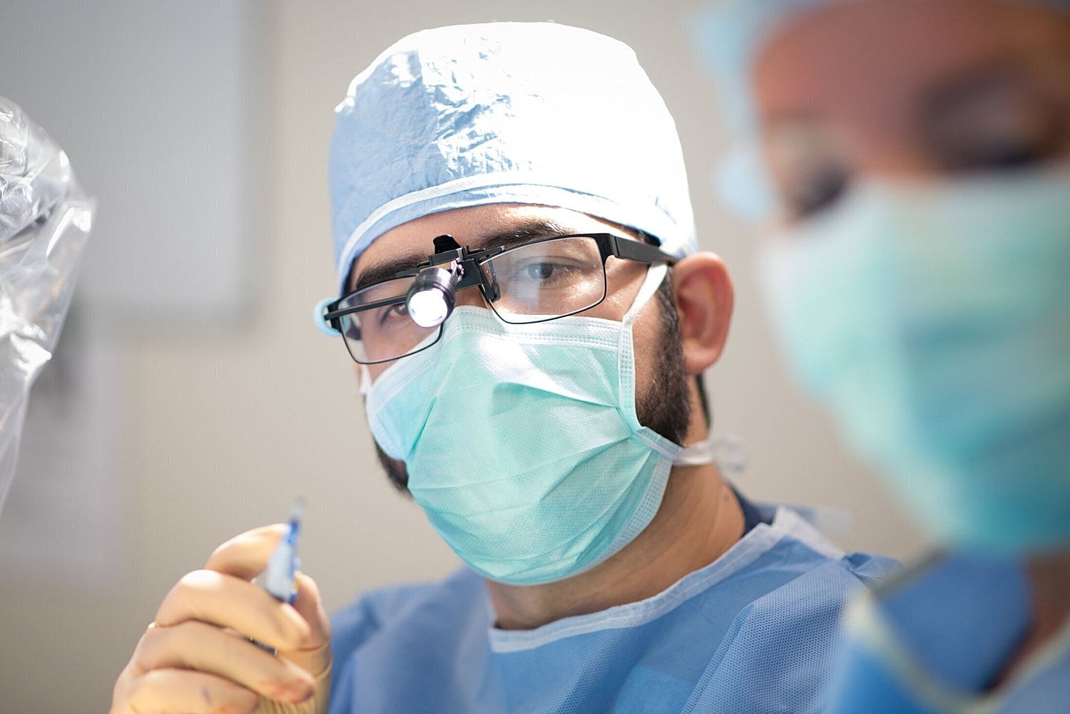 orlando plastic surgeon wearing a mask and surgical glasses