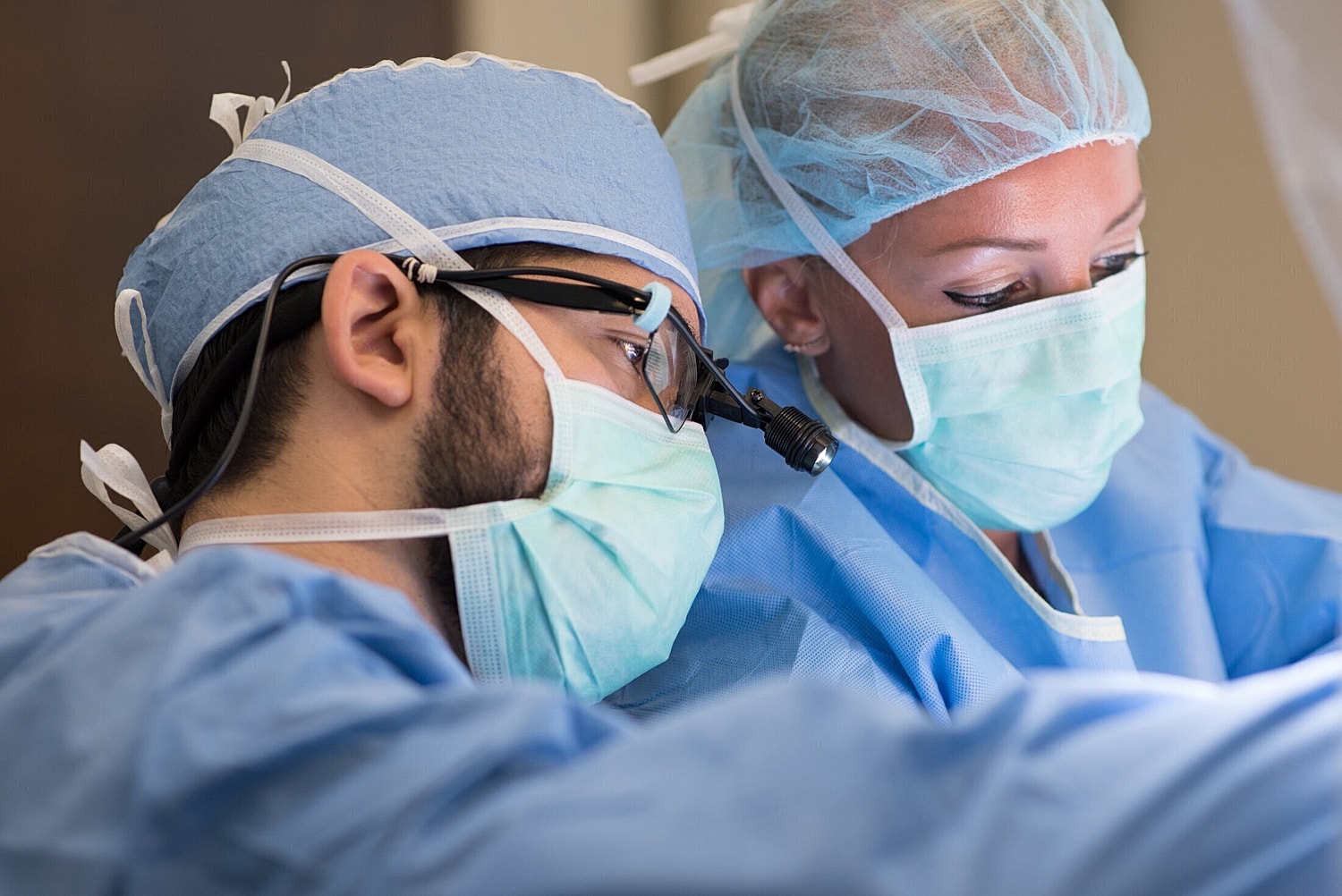 orlando plastic surgeon showing assistant something