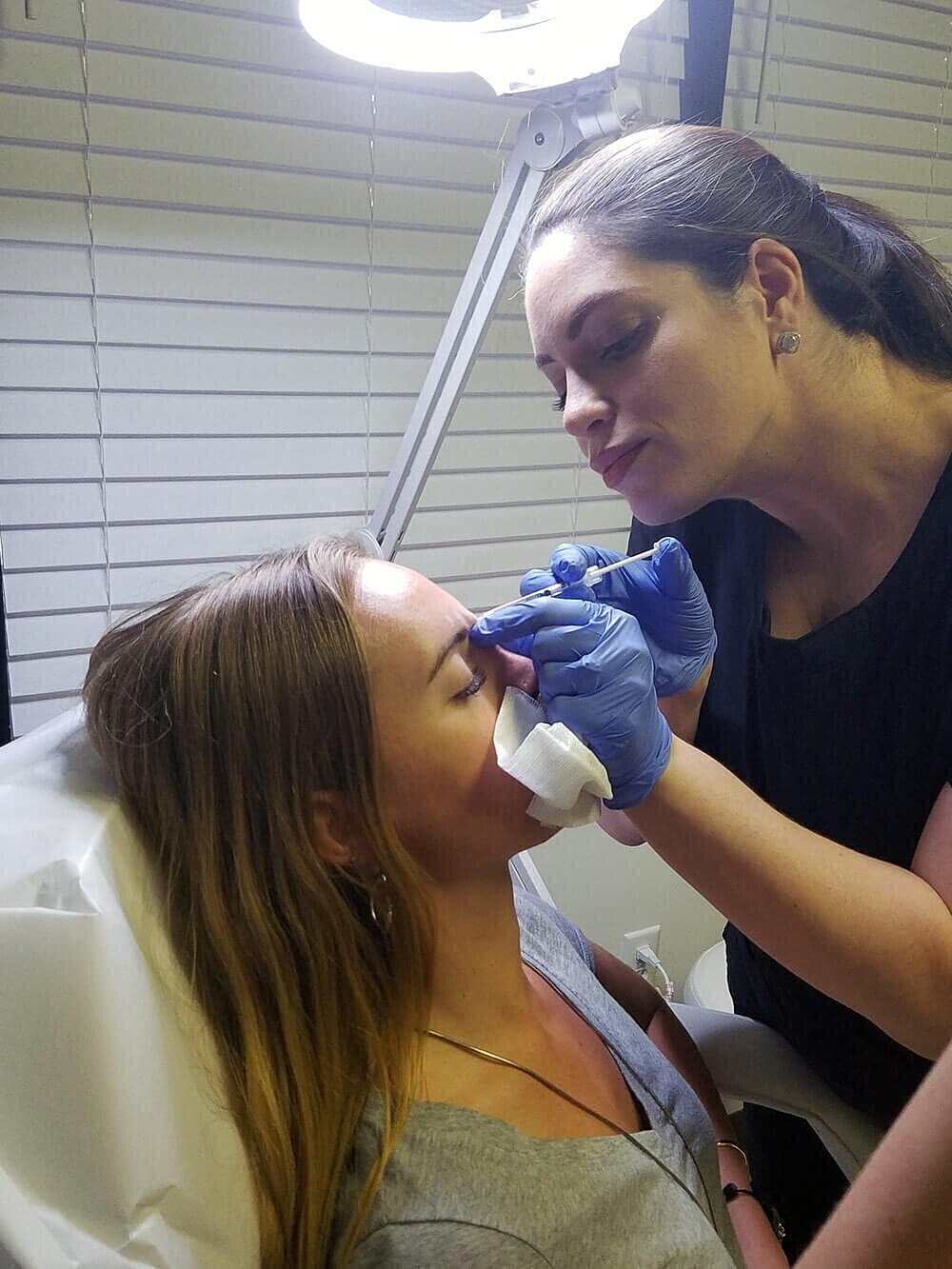Eyebrow tattooing procedure in a beauty studio.