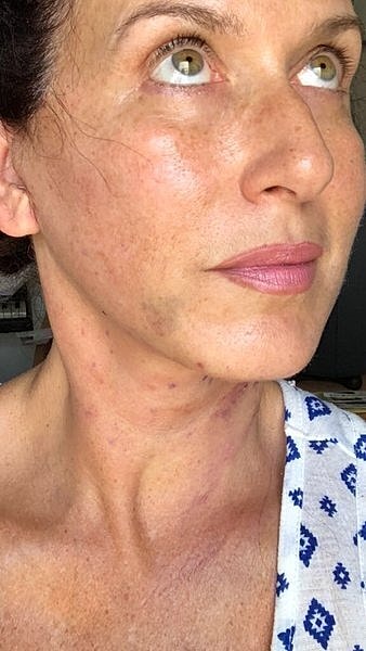 Woman looking upward with natural makeup.