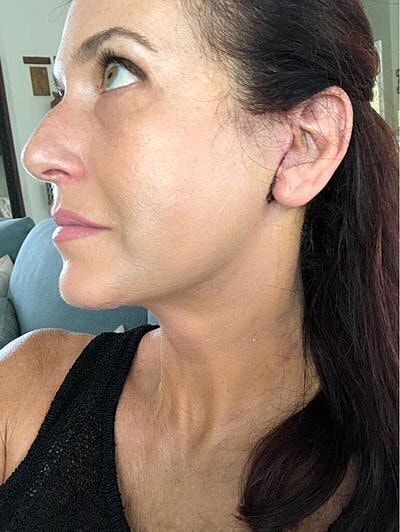 Profile view of woman with natural makeup.