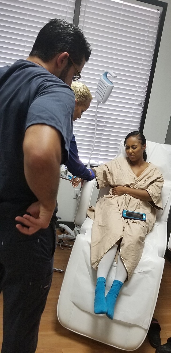 Patient receiving medical attention in clinic setting.
