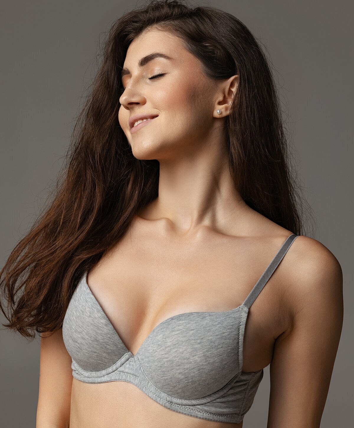 Model in gray bra with closed eyes.