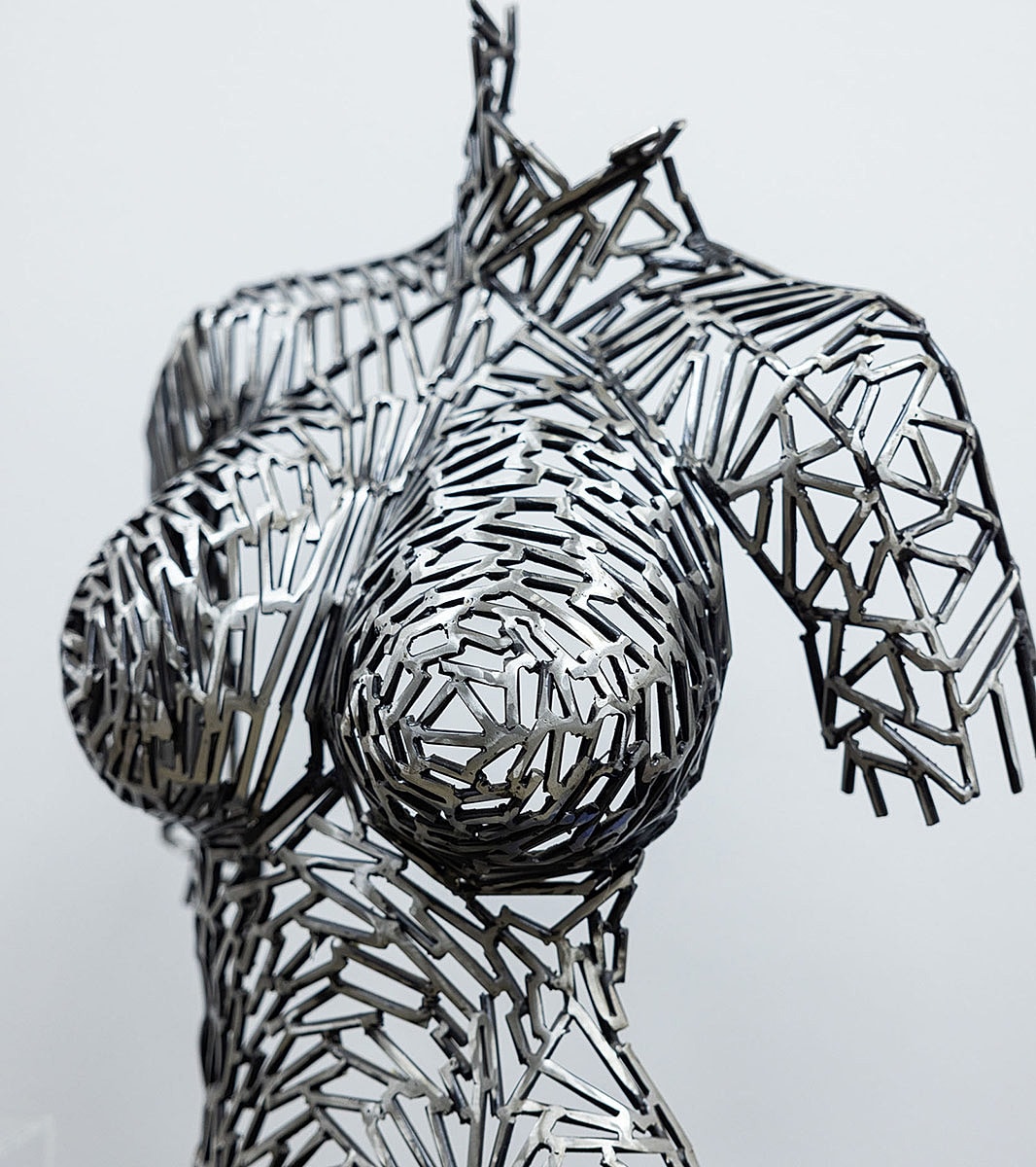 Abstract metal sculpture depicting a human torso.