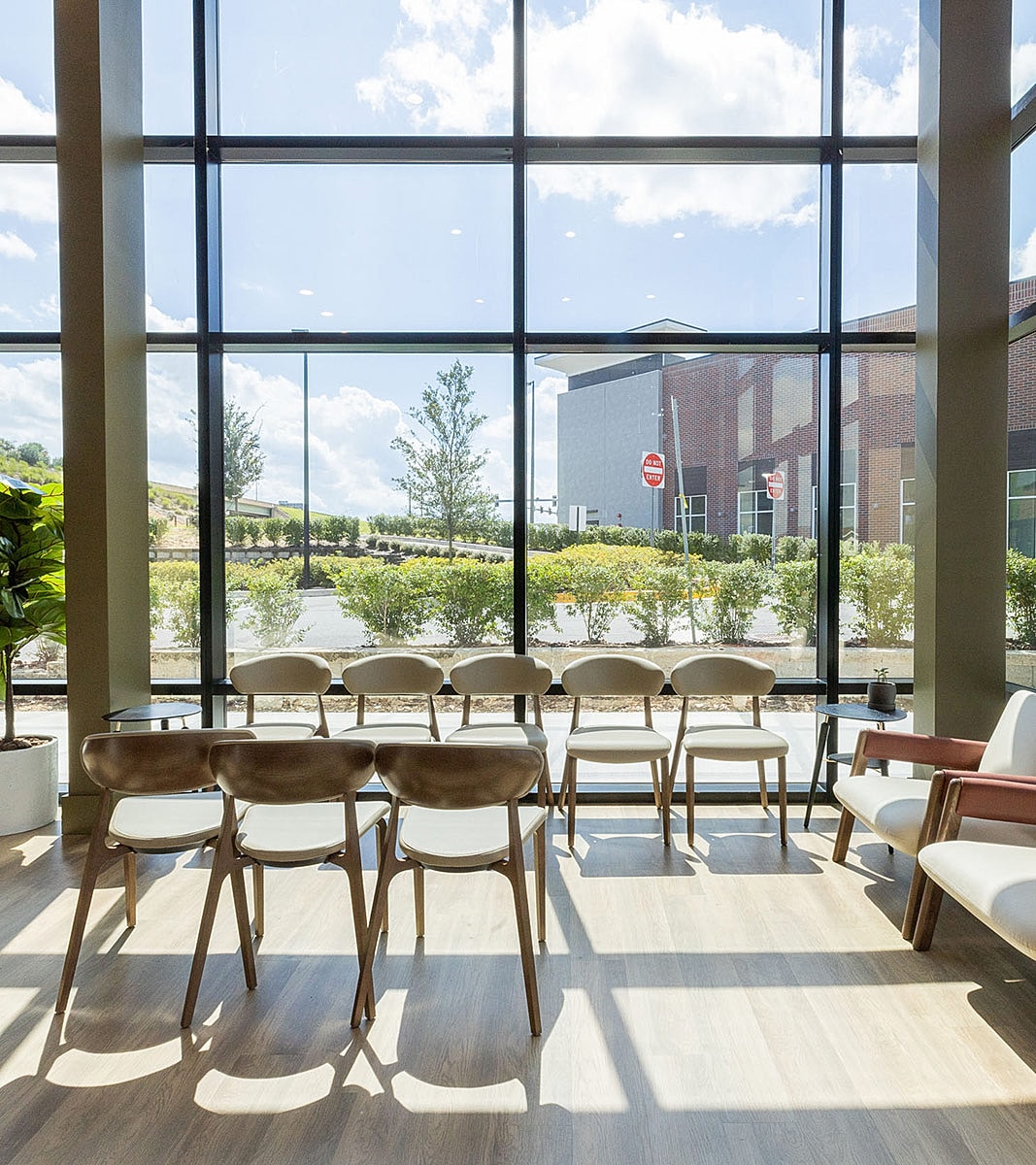 Modern waiting area with stylish chairs and sunlight.