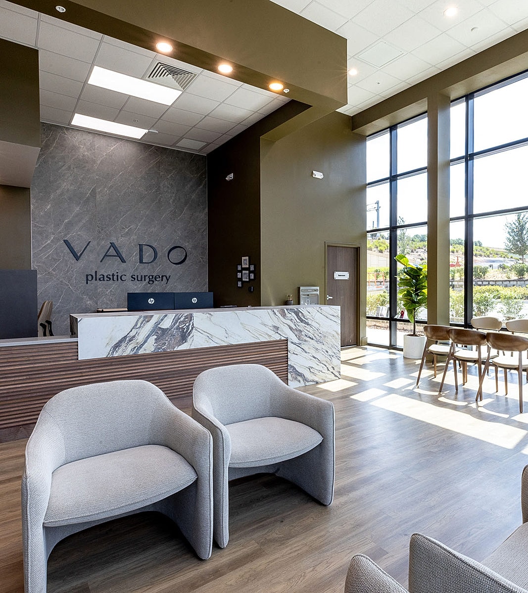 Modern plastic surgery clinic waiting area interior.