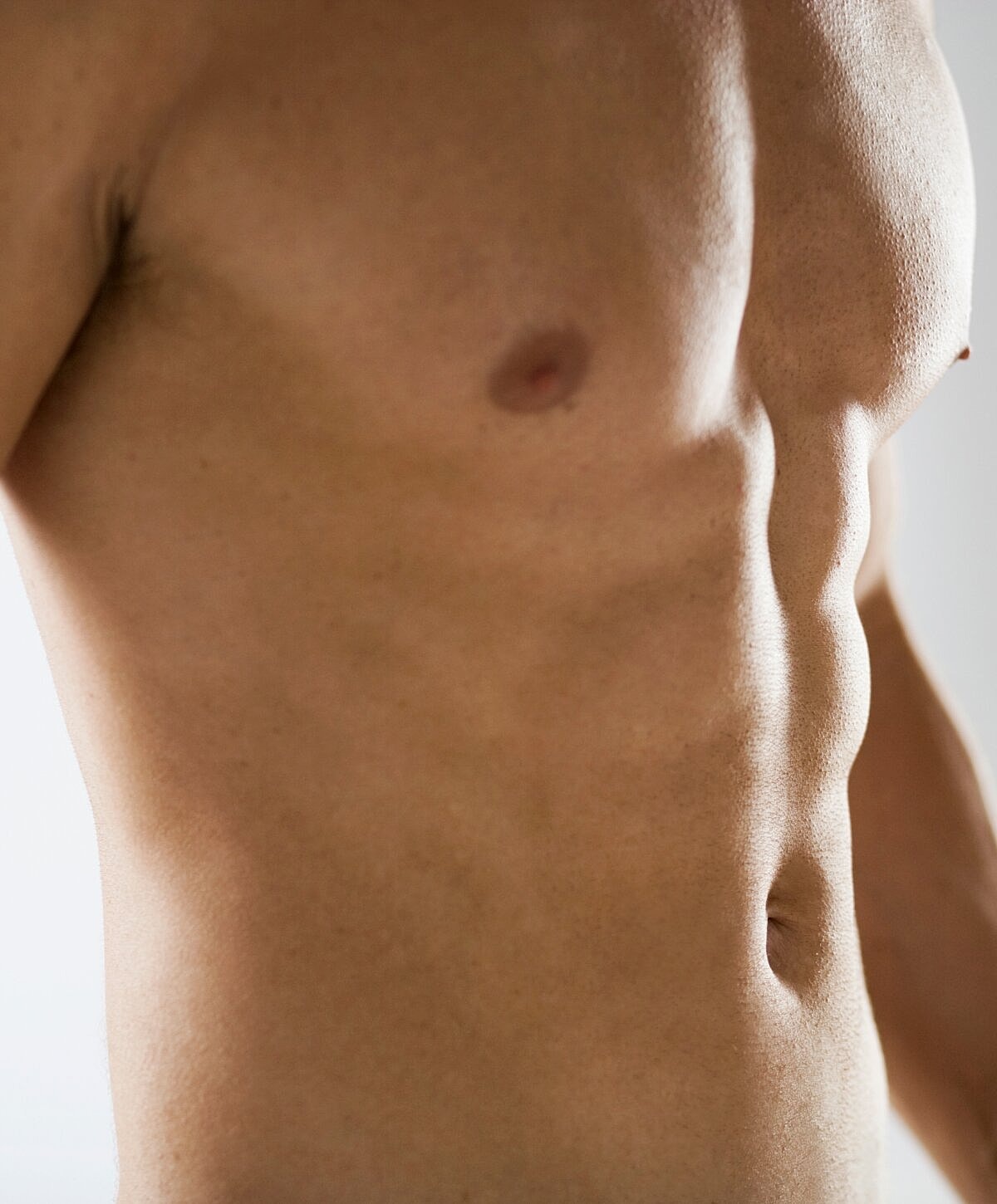 Close-up of fit male torso and abdomen.